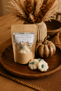 Frosted Pumpkin soy wax melts in a kraft bag with white pumpkin-shaped melts