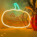 Happy Pumpkin LED neon light glowing orange and green on a table beside autumn decorations