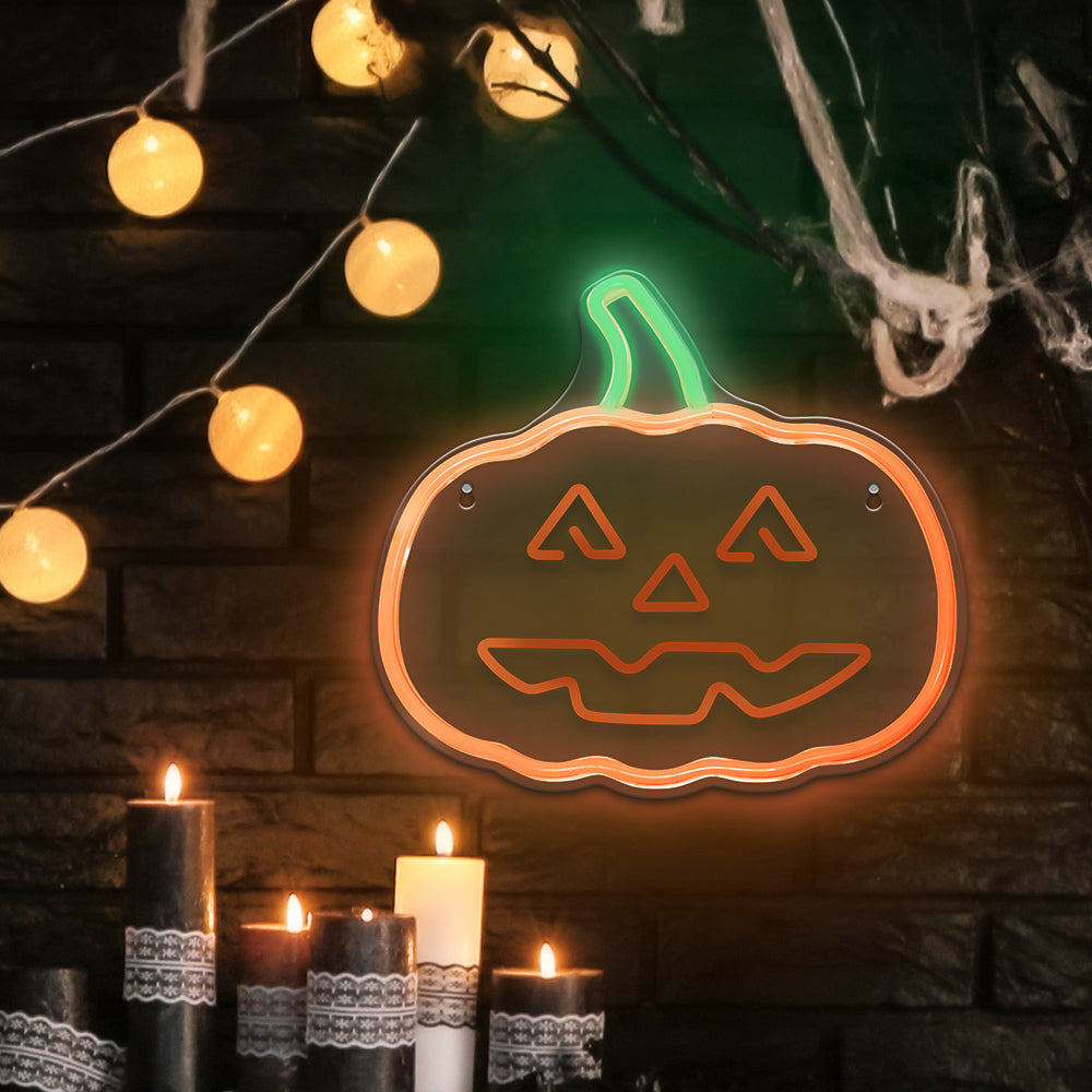 Happy Pumpkin LED neon light on a dark brick wall with candles and fairy lights