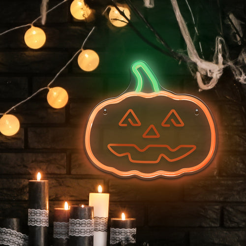 Happy Pumpkin LED neon light on a dark brick wall with candles and fairy lights